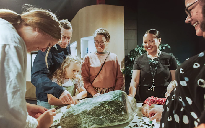 Group examining jade stone during Mountain Jade Highlights Tour.