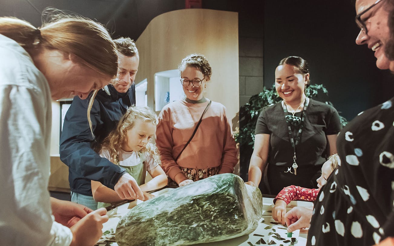 Group examining jade stone during Mountain Jade Highlights Tour.
