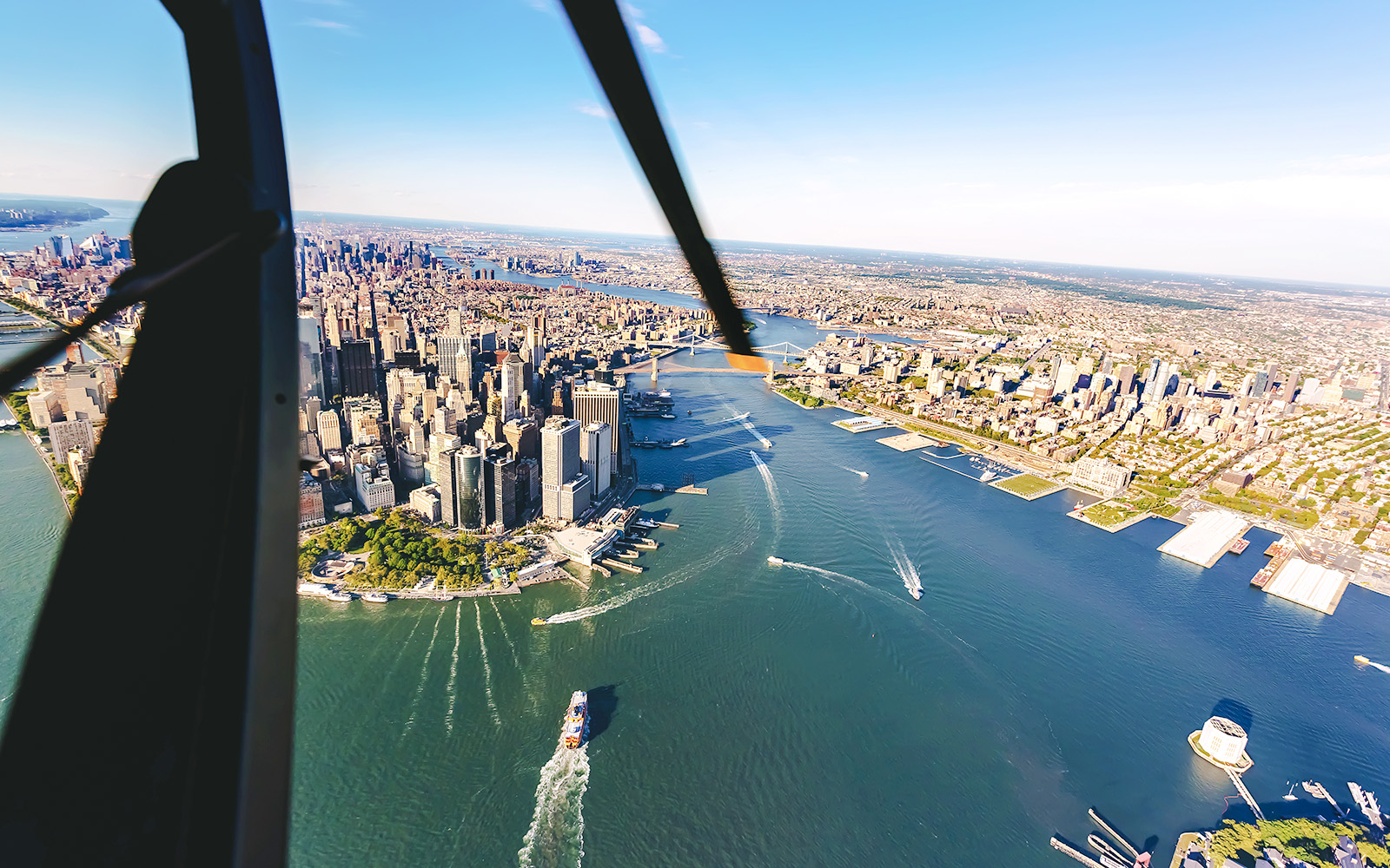 Aerial view of lower Manhattan skyline and East River from a helicopter.