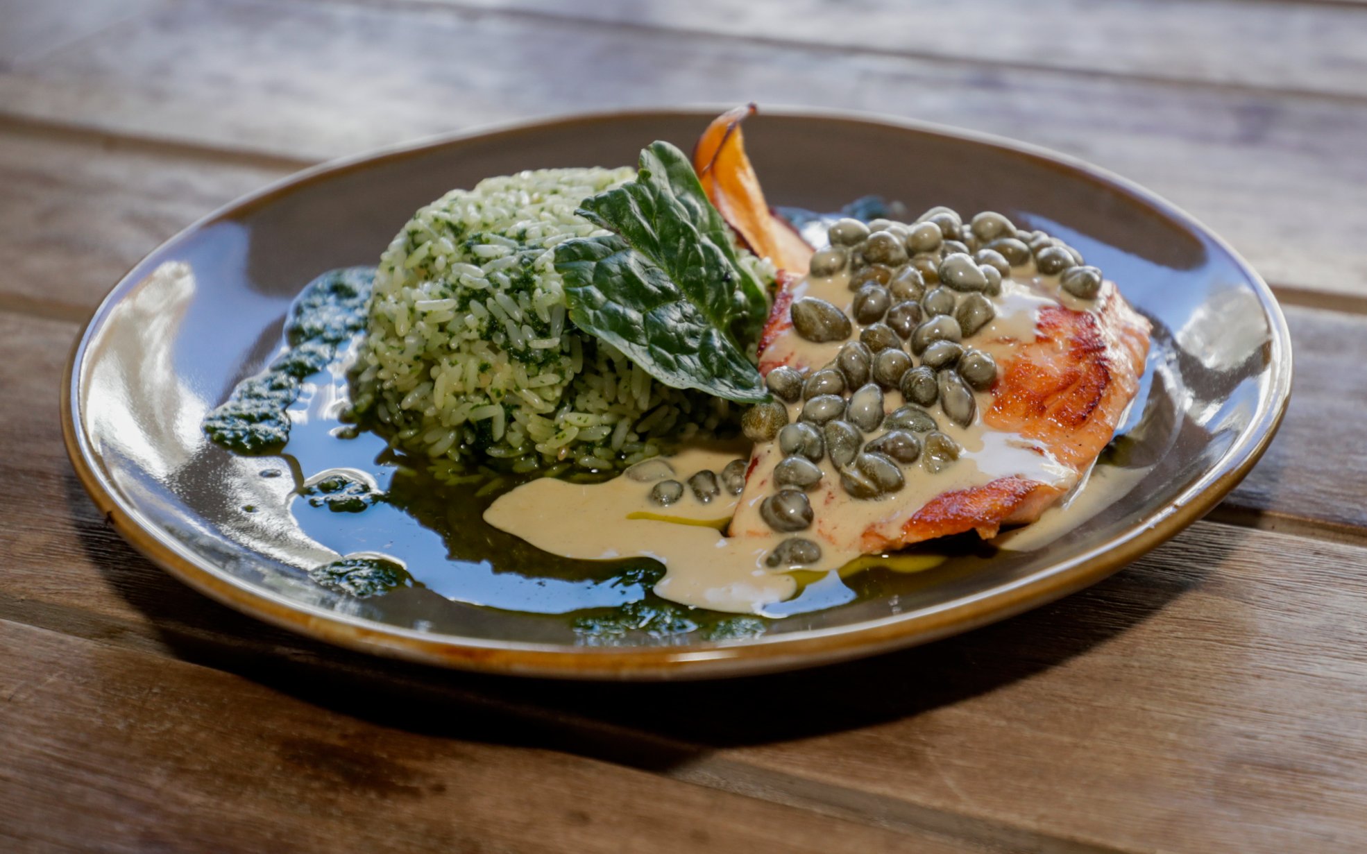 Grilled salmon with caper sauce and spinach rice at El Morado Lodge and Spa.
