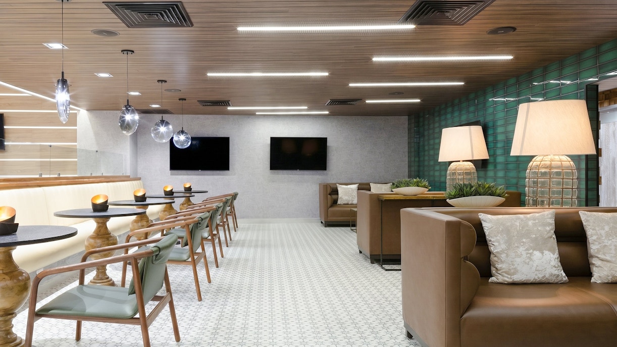 MERA Business Lounge seating area with modern decor at Cancun International Airport.