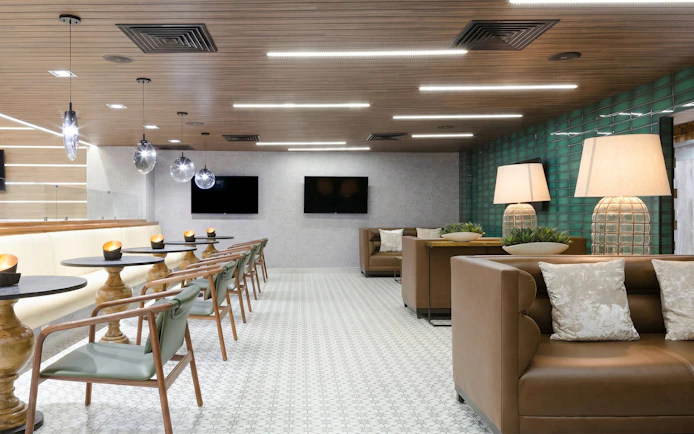 MERA Business Lounge seating area with modern decor at Cancun International Airport.
