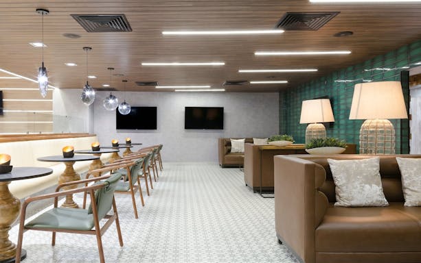 MERA Business Lounge seating area with modern decor at Cancun International Airport.