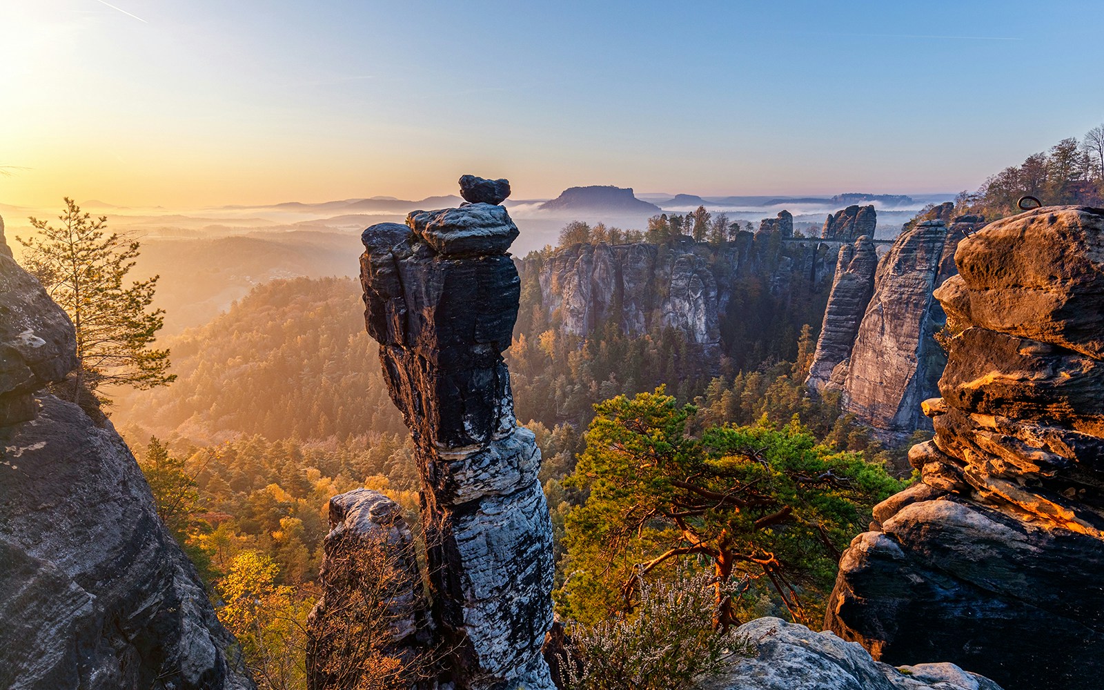 Wehlnadel rock formation at sunrise in Saxon Switzerland National Park, Germany.