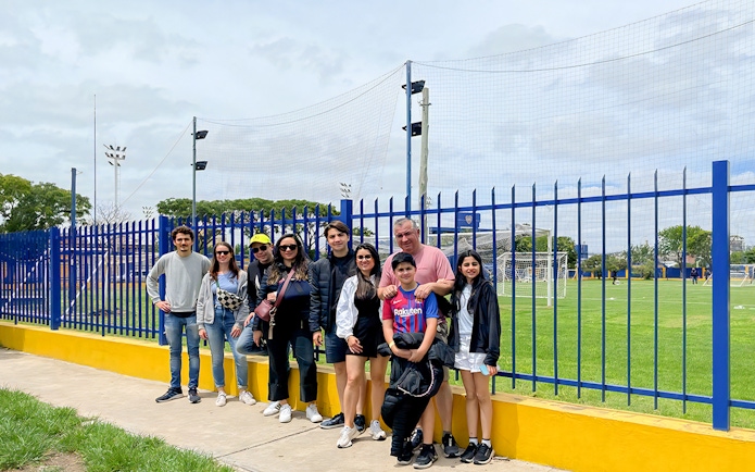 Tourists posing for photos near La Bombonera stadium in Buenos Aires.
