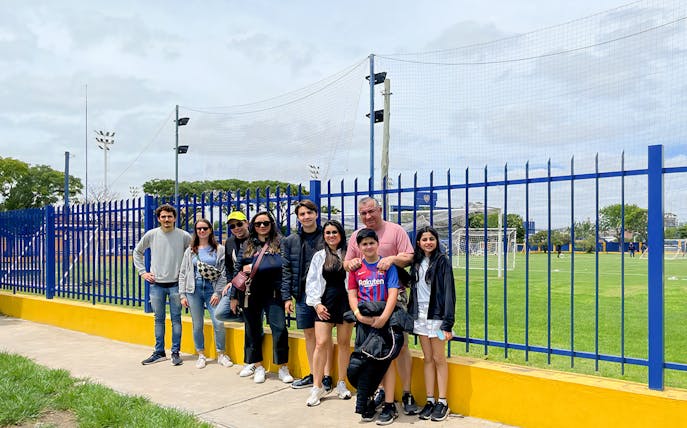 Tourists posing for photos near La Bombonera stadium in Buenos Aires.