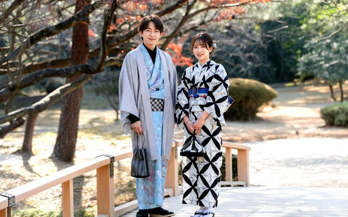 Couple in traditional kimonos at Shinjuku Gyoen National Garden, Tokyo.