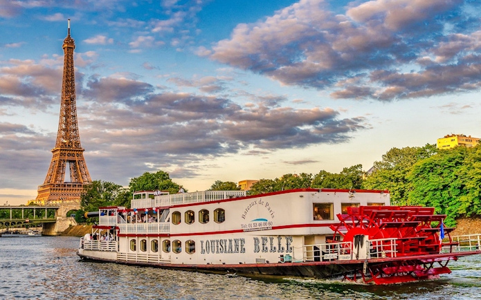 Seine River cruise boat near Eiffel Tower, Paris, France.