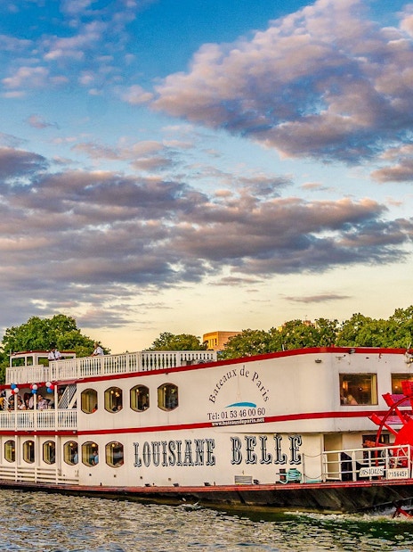 Seine River cruise boat near Eiffel Tower, Paris, France.