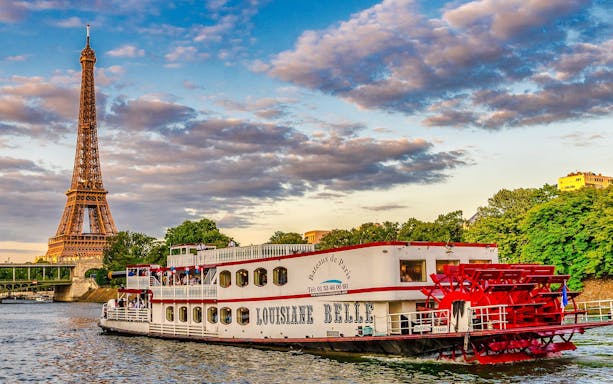 Seine River cruise boat near Eiffel Tower, Paris, France.