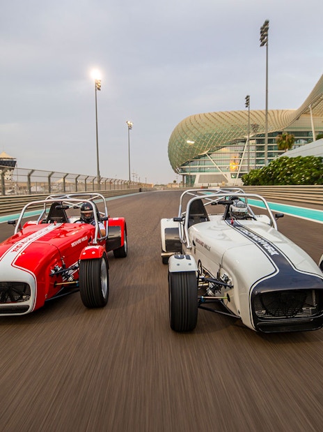 Caterham Seven 360 cars racing at Yas Marina Circuit in Abu Dhabi.