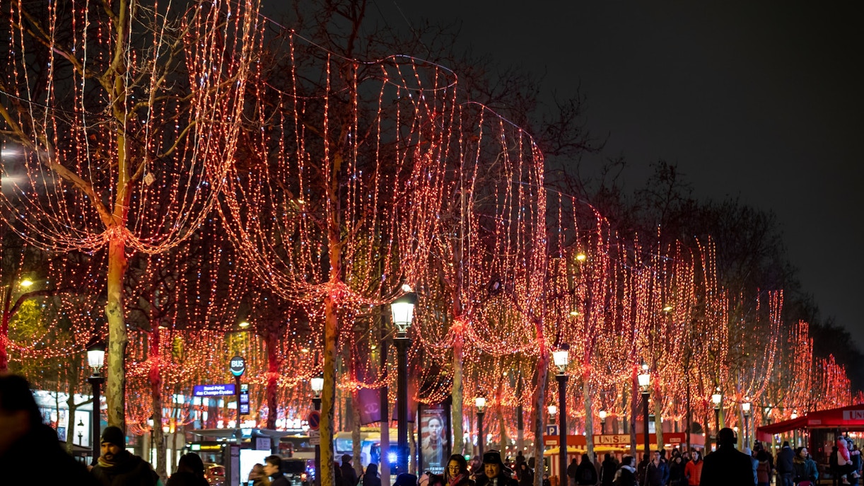 Champs Elysees adorned with red Christmas lights, Paris.