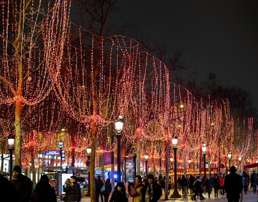 Champs Elysees adorned with red Christmas lights, Paris.