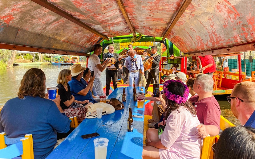 Mariachi band performing on a colorful boat during a Xochimilco tour in Mexico City.