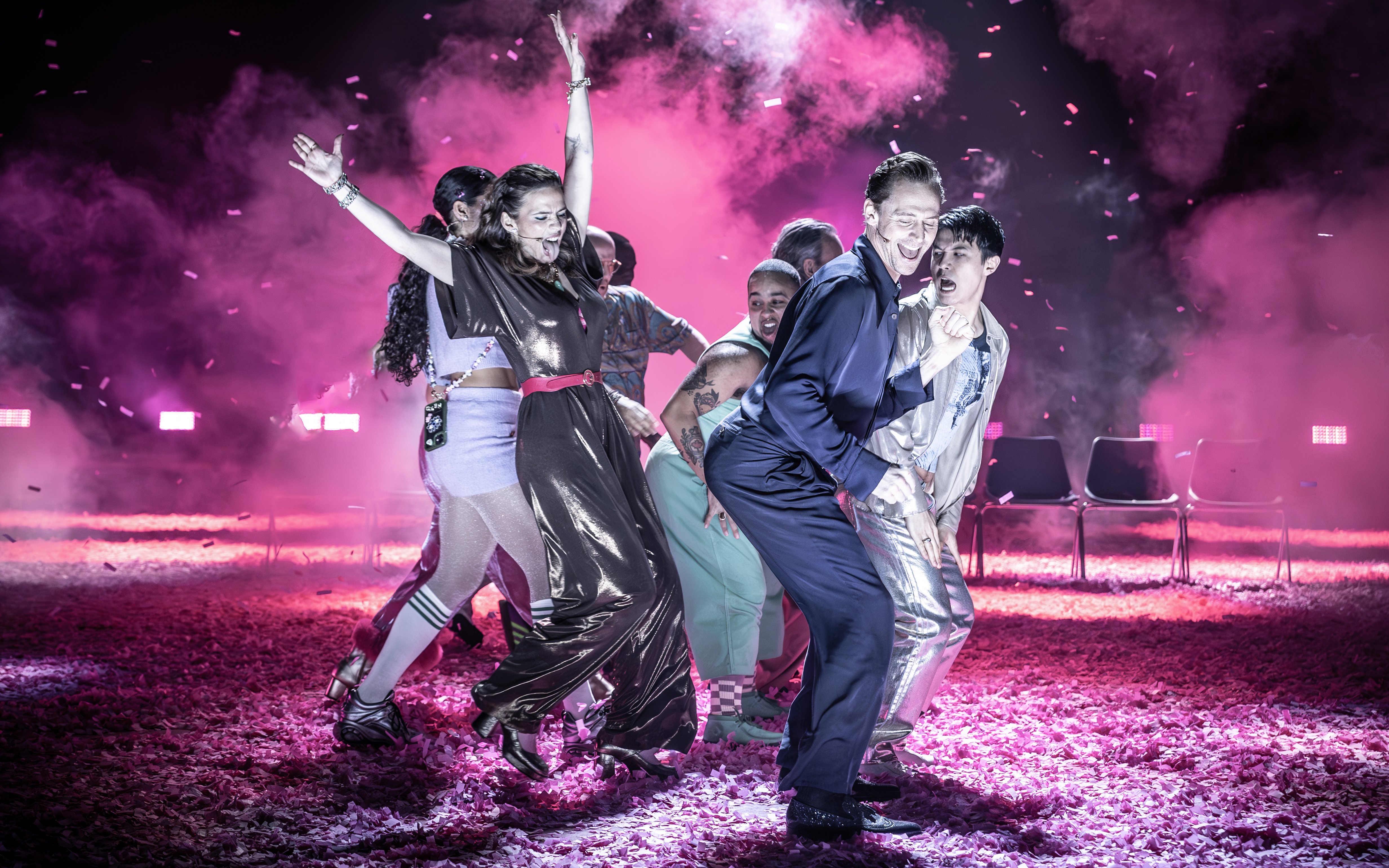 Actors performing Much Ado About Nothing on a vibrant Broadway stage.