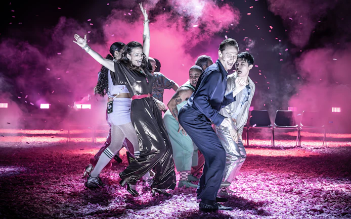 Actors performing Much Ado About Nothing on a vibrant Broadway stage.