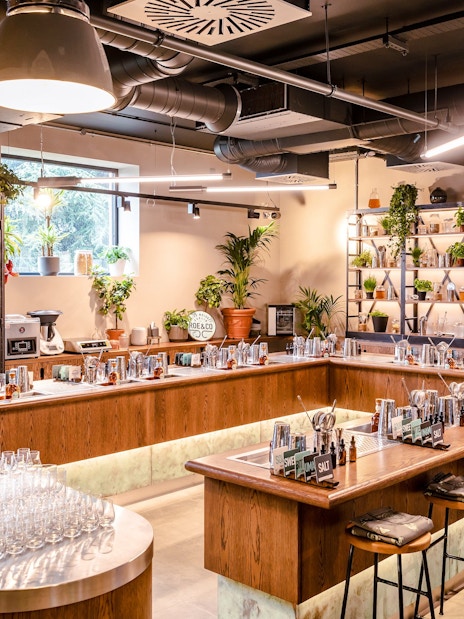 Roe & Co Distillery cocktail workshop setup with bar tools and plants.