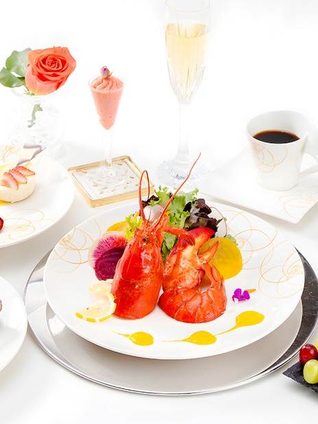 Seafood platter with lobster, assorted fruits, and gourmet dishes on Nova Five Star 2.