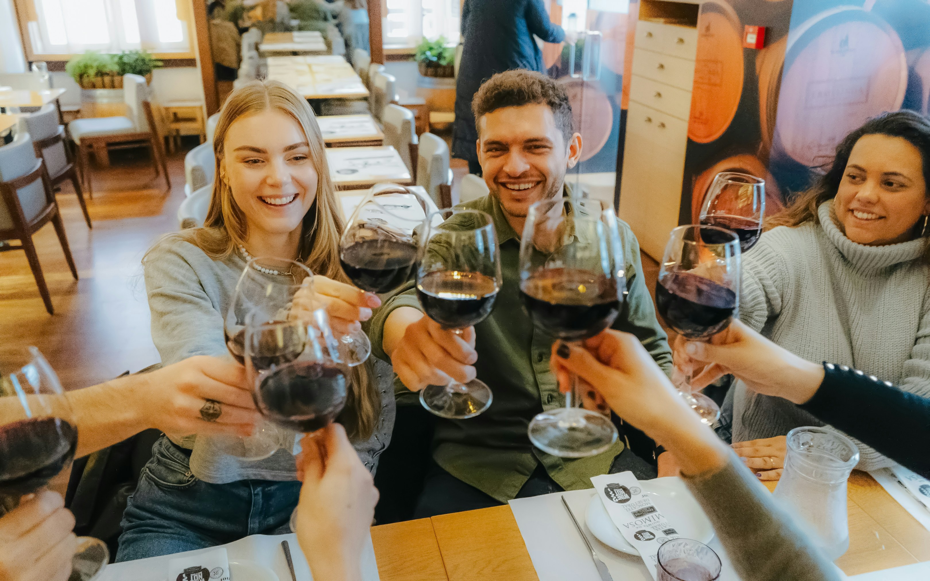 Group toasting with wine glasses during Lisbon food tour.