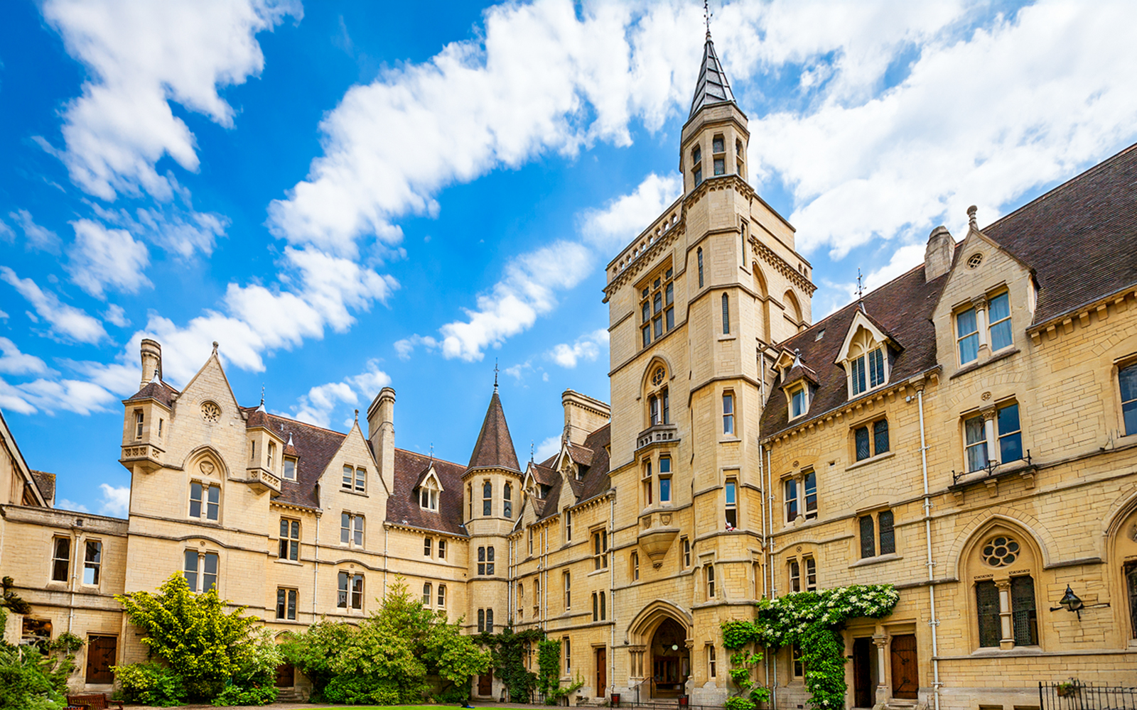 Balliol College's historic architecture under a blue sky in Oxford, England.