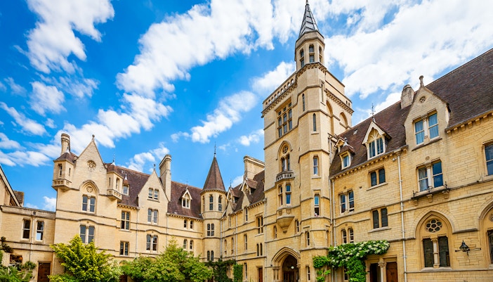 Balliol College's historic architecture under a blue sky in Oxford, England.