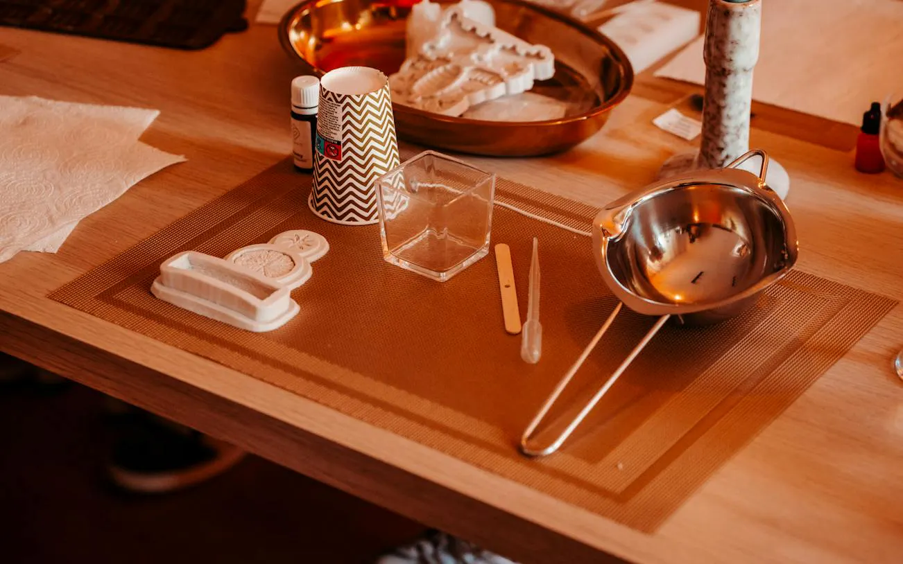 Candle-making tools and materials on a table at a Krakow luxury studio workshop.