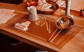 Candle-making tools and materials on a table at a Krakow luxury studio workshop.