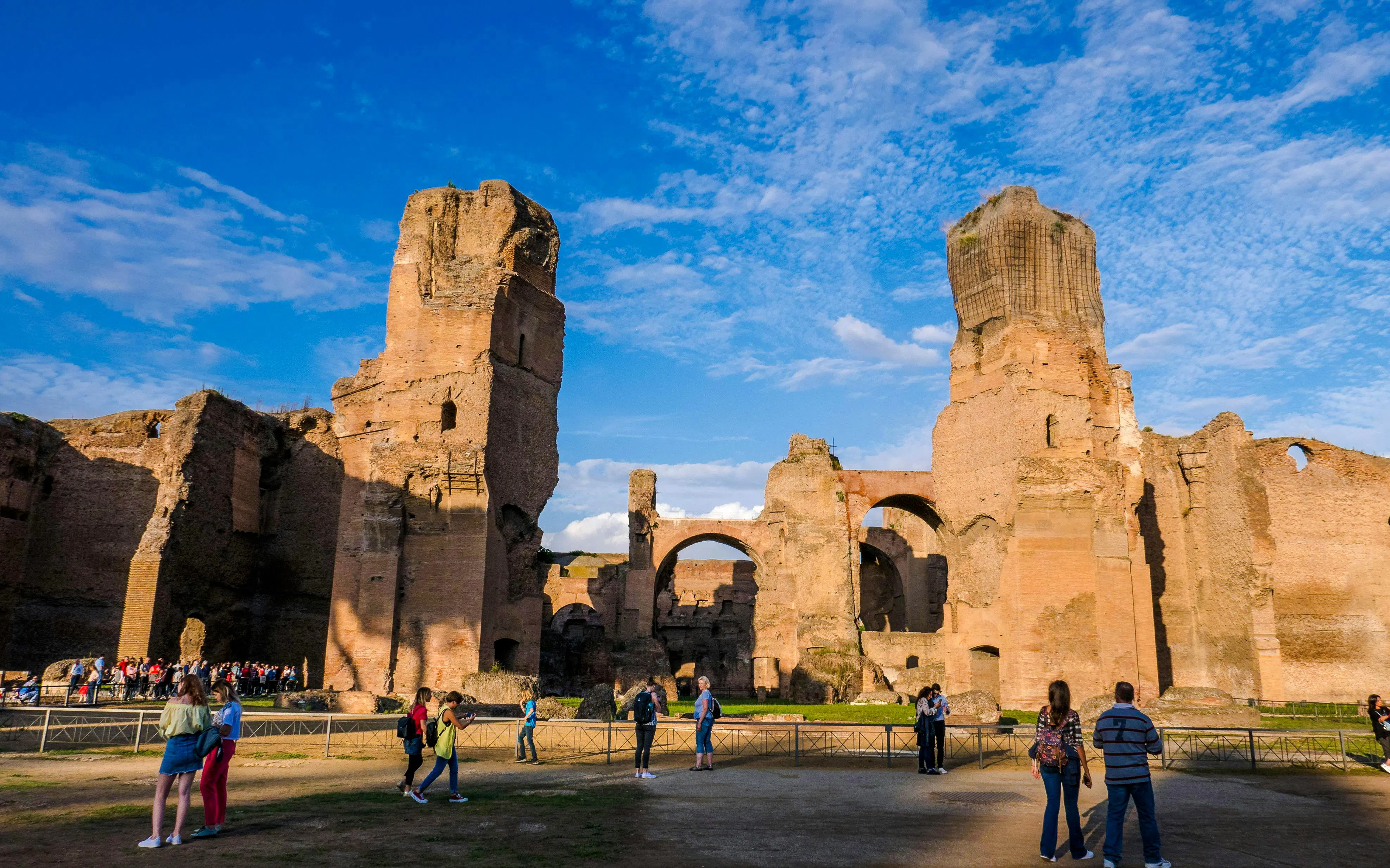 Terme di Caracalla ruins with tourists exploring, panoramic view in Rome, Italy.
