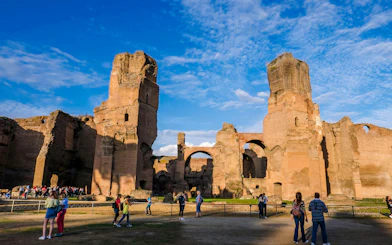 Terme di Caracalla ruins with tourists exploring, panoramic view in Rome, Italy.