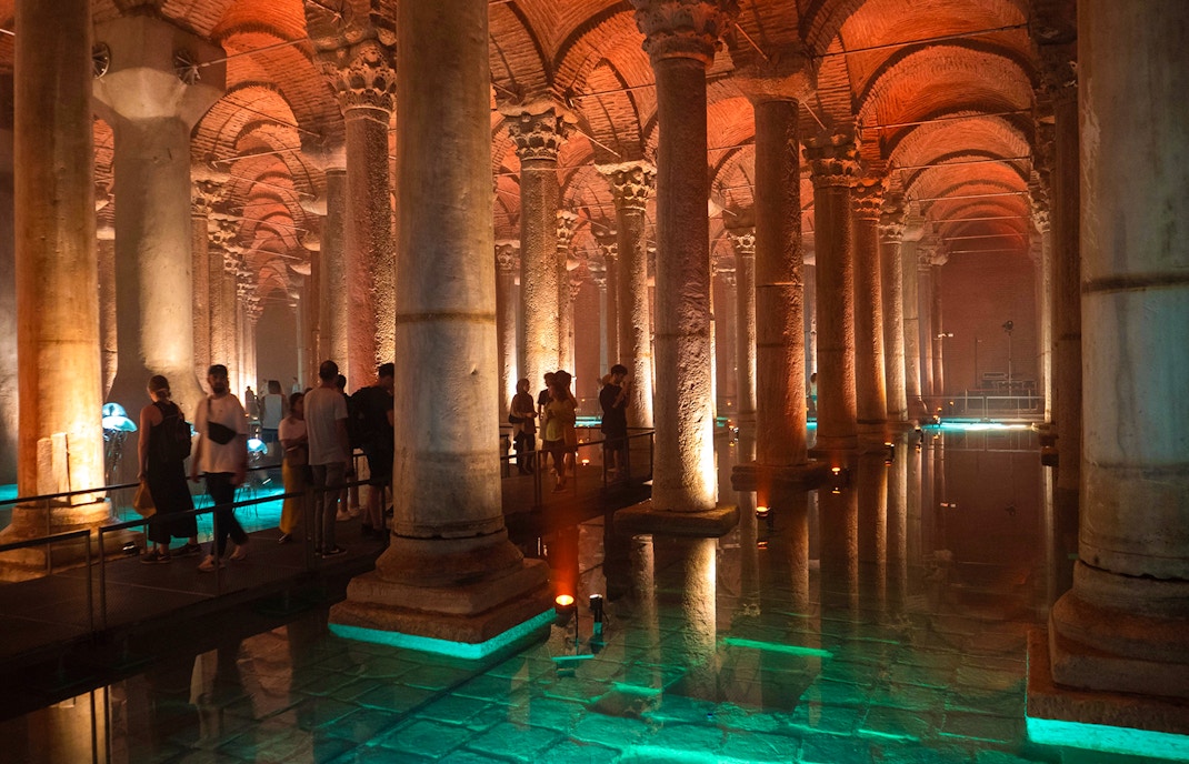 Guided tour inside Basilica Cistern, Istanbul, showcasing ancient columns and vaulted ceilings.