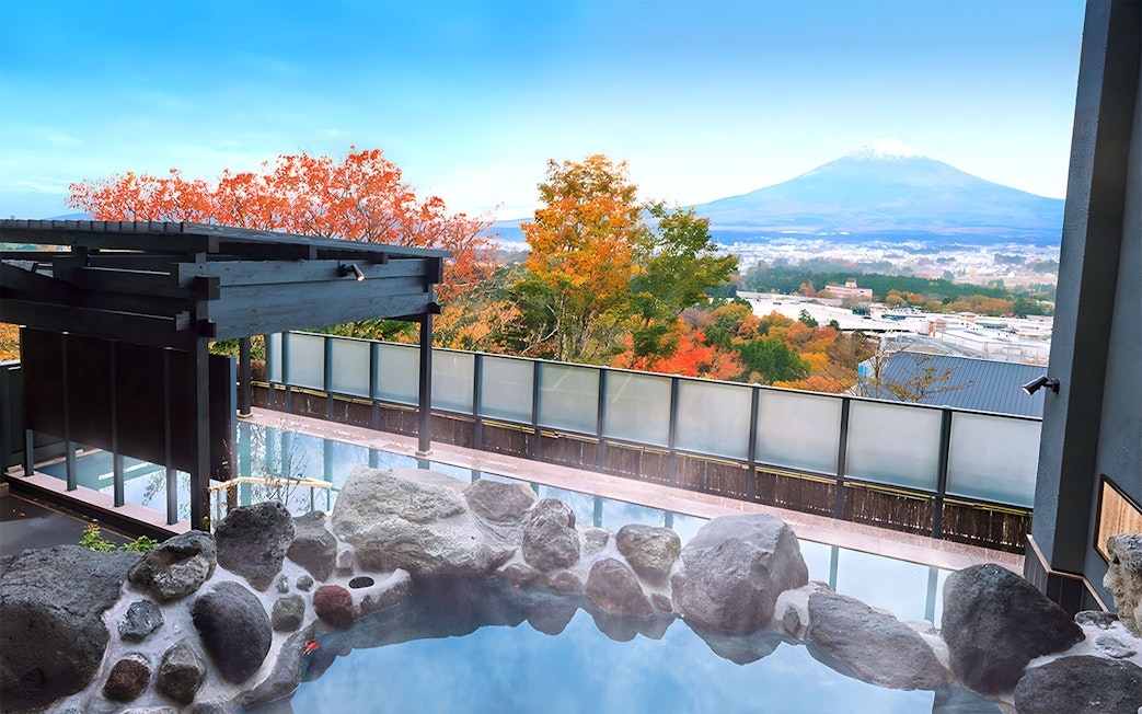 Konohananoyu hot springs with view of Mt. Fuji and autumn foliage.