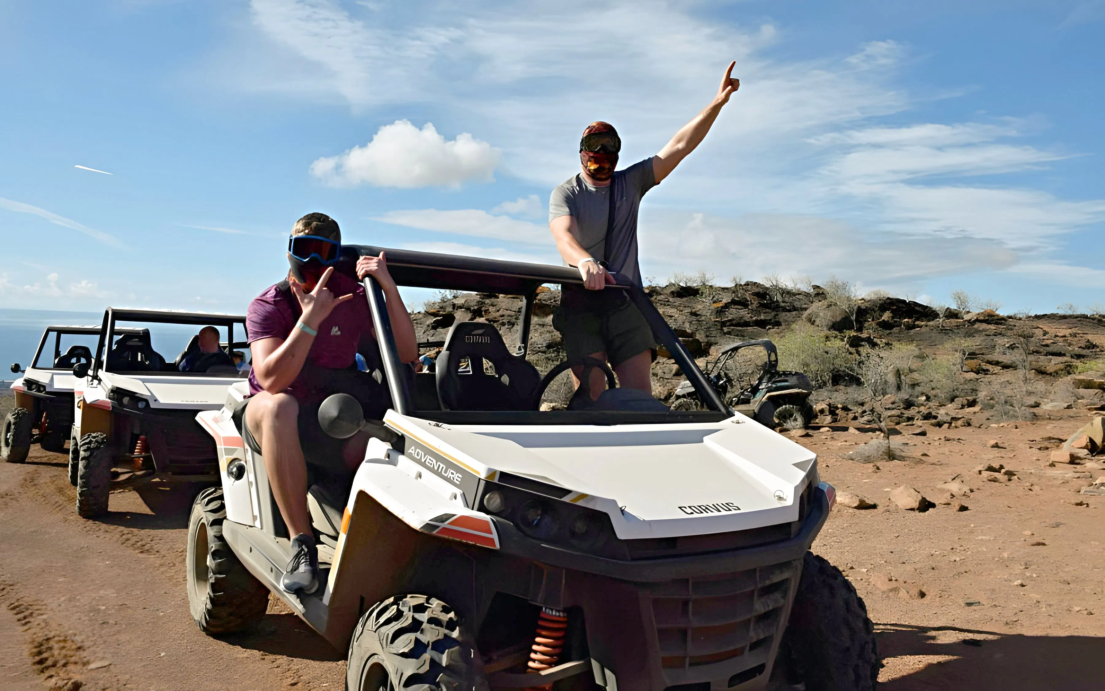 Off-road buggies driving through rocky terrain in Gran Canaria.