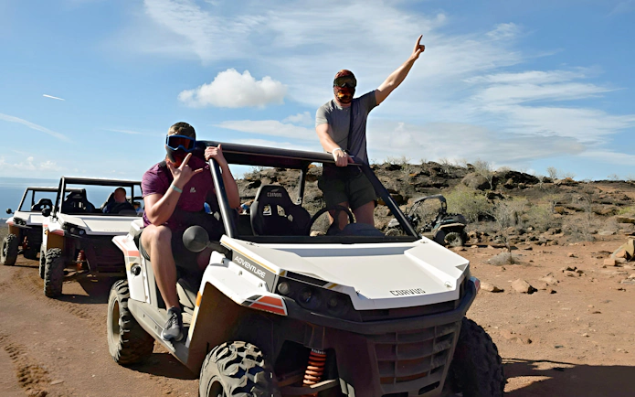 Off-road buggies driving through rocky terrain in Gran Canaria.