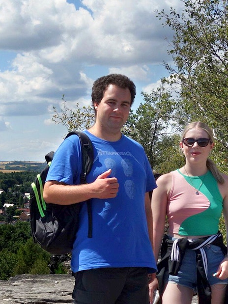 Group of tourists on a guided tour of Bastei Bridge and Tisa Walls Labyrinth, surrounded by trees.