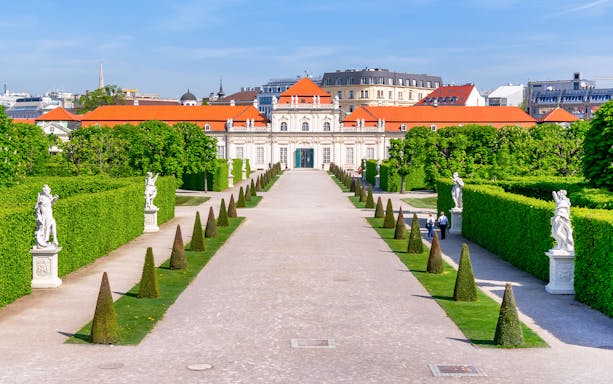 Lower Belvedere palace gardens with statues and hedges in Vienna.