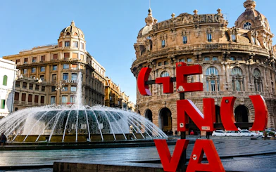 Fountain and historic buildings in Piazza De Ferrari, Genoa.