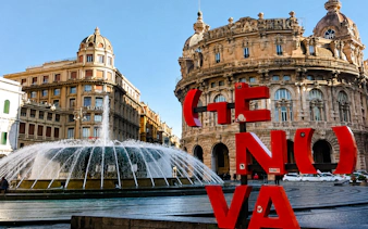 Fountain and historic buildings in Piazza De Ferrari, Genoa.