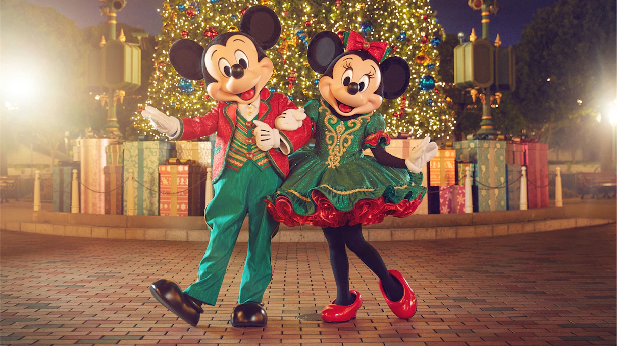 Mickey and Minnie Mouse in festive outfits at Disneyland Hong Kong Christmas display.