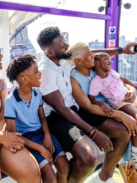 Family enjoying a ride on the IFS Cloud Cable Car in London.