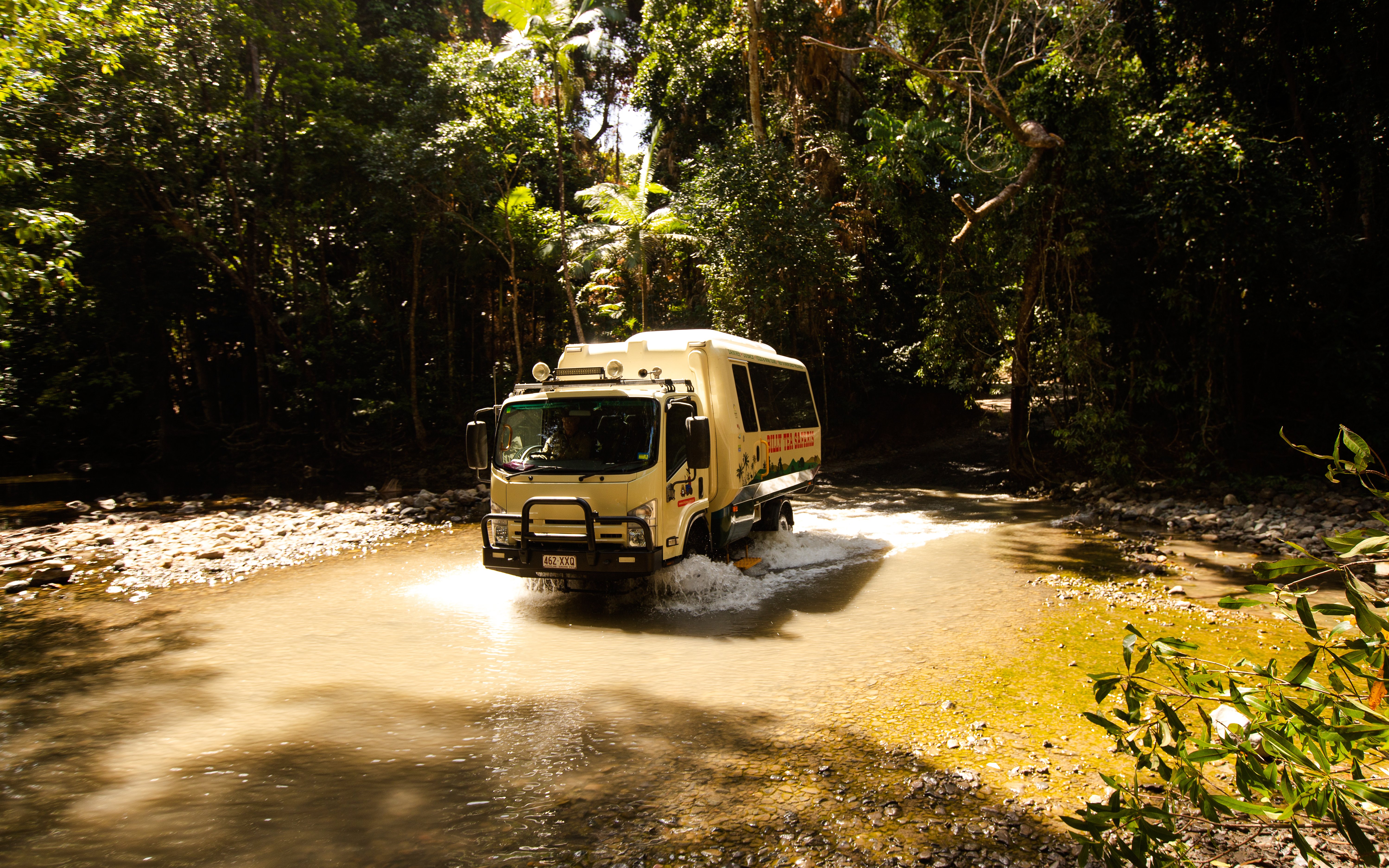Tour vehicle crossing a stream in Daintree Rainforest, Billy Tea Safaris, Cape Tribulation.