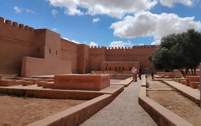 Ancient fortress walls in Agadir under a blue sky, part of Sahara Desert adventure tour.