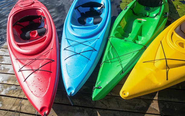 Colorful kayaks on a dock for Sorrento Coast to Crapolla Fjord tour.
