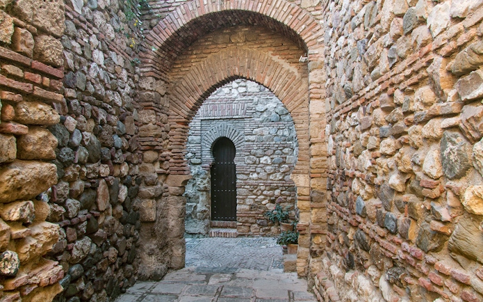 Stone archway in Alcazaba Castle, Málaga, on Roman Theater walking tour.