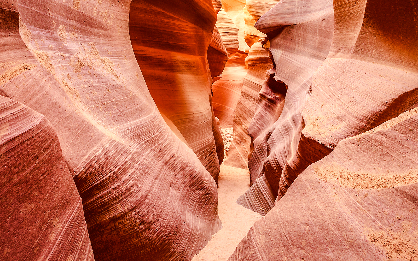 Lower Antelope Canyon's narrow sandstone passage with smooth, curved walls.