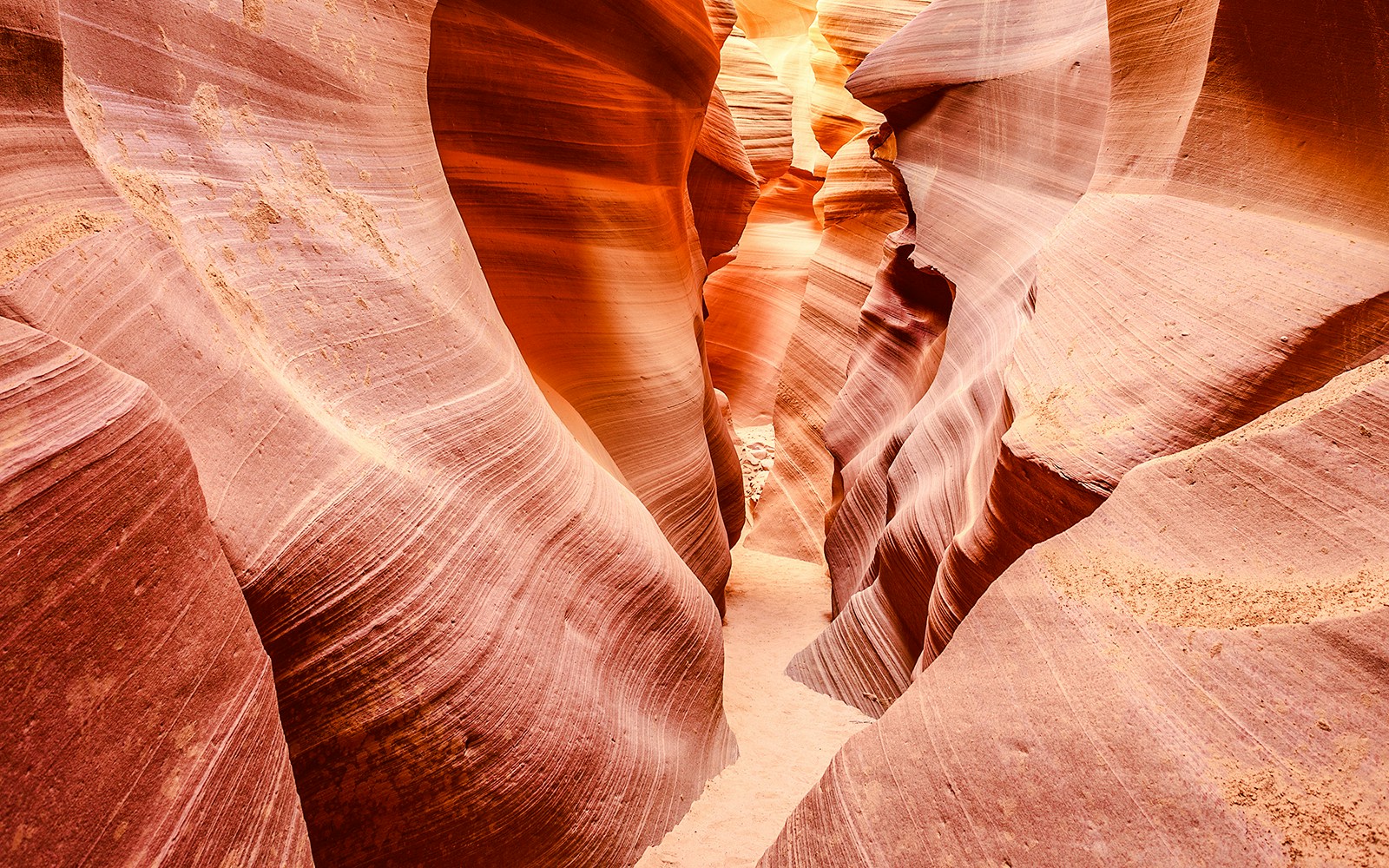 Lower Antelope Canyon's narrow sandstone passage with smooth, curved walls.