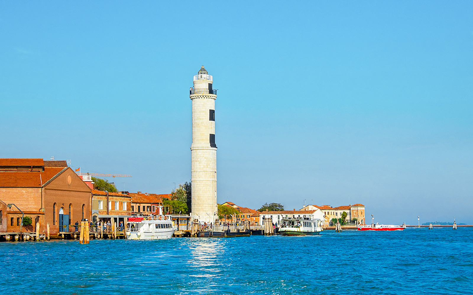 Faro di Murano lighthouse in Venice, Italy, with a view of the surrounding lagoon.