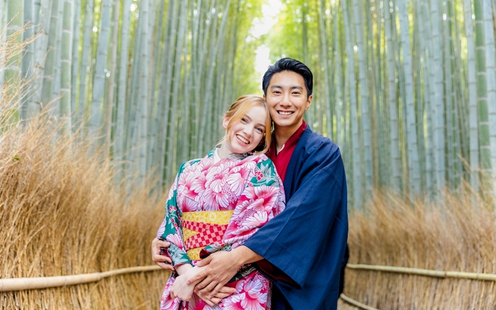 Couple in kimonos at Kyoto Bamboo Forest, Japan.