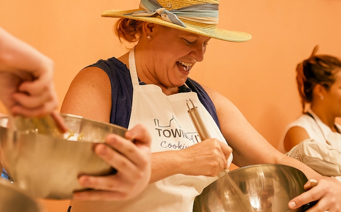 Person participating in a cooking class in Florence, mixing ingredients in a bowl.
