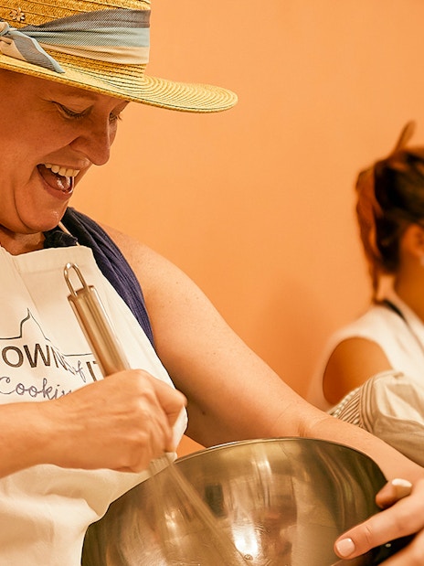 Person participating in a cooking class in Florence, mixing ingredients in a bowl.