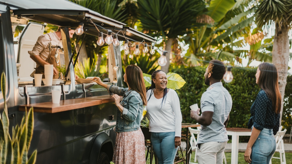 People enjoying food at a truck during the TREK Food Truck Festival.